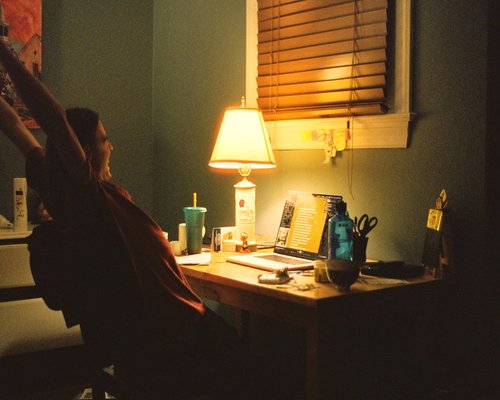 Person stretching gently next to an office desk