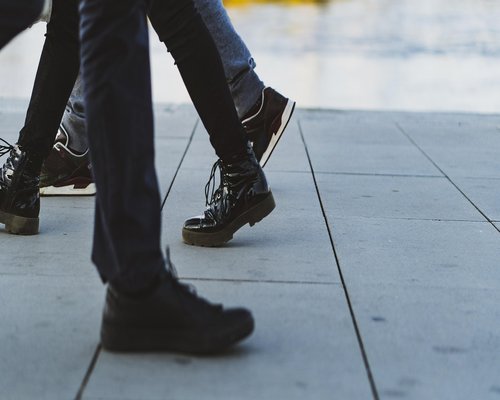 Close up of comfortable walking shoes on a city sidewalk